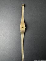 Full view of vintage women's Cardinal gold-tone wristwatch with textured mesh band and rectangular face