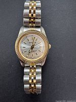 Full shot of the vintage women's Gruen Precision watch showing two-tone metal band and fluted gold-tone bezel.