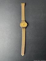Full view of the vintage women's Timex wristwatch showing the gold-tone mesh band and oval dial.