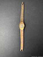 Full length photo of vintage Timex women's watch showing the gold-toned linked bracelet and square dial.