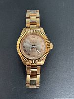 Front view of gold tone Invicta women's wristwatch showing the dial, textured bezel, and bracelet.