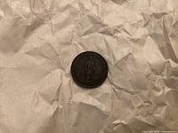 Obverse side of the 1837 1/2 penny coin showing a standing figure and French inscription.