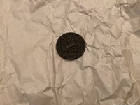 Front side of the One Penny Token, 1857, showing Saint George and the dragon image with date.