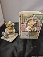 Front view of 1992 Cherished Teddies Patrice figurine and 1997 Cherished Teddies book figurine showing front details