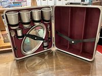 Open look at the Executair travel bar case with metal cups, tray, and bar tools secured inside.