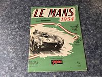 Front cover of the 'Le Mans 1954' vintage book showing a race car with number 4 and green background.