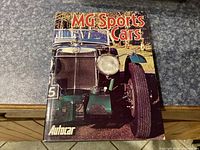 Front cover of MG Sports Cars book showing a vintage green MG car photo.
