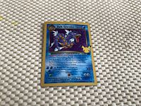 Photo of front side of Dark Gyarados 70 HP Pokémon card showing holographic design and card details.