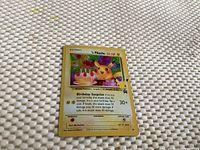 Front of the early Pikachu Pokemon card showing Pikachu with birthday cake, 50 HP, and Birthday Surprise attack details.