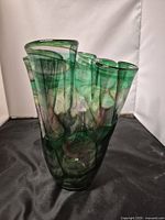 Front view of freeform art glass vase showing overall shape and coloration