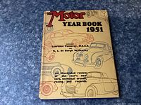 Front cover of The Motor Year Book 1951 showing title, author names and illustrated cars.