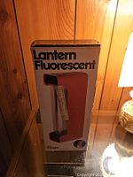 Front view of boxed AFC fluorescent lantern