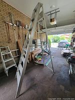 Ladder fully opened in garage showing both sides and overall structure