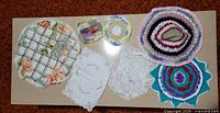All seven doilies and mats displayed on tabletop