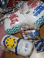 Overall lot showing two stuffing bags, poly spun roll, bag of yarn and basket