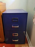 Front view showing both drawers, pulls, label frames, and lock