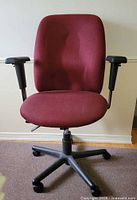 Front view showing burgundy upholstery, armrests, five-star base