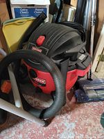 Craftsman shop vacuum with hose and wand extensions visible