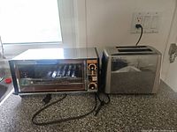 Toaster oven and toaster side by side on countertop