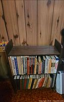 Front view showing full bookshelf with two shelves and dark brown wood-grain laminate surfaces