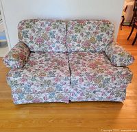 Front view of floral loveseat showing overall appearance