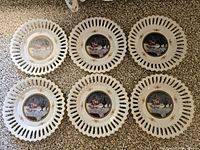 Six plates fronts displayed showing fruit design and pierced rims