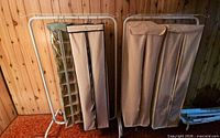 Two garment racks side by side with covers and shoe organizer
