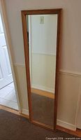 Front view of full-length mirror with wood frame