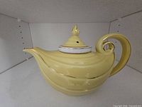 Left side view of yellow Hall teapot with lid on