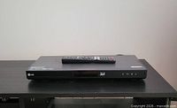Front view of LG Blu-ray player with remote on top