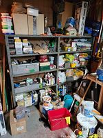 Front view of entire grey metal shelving unit filled with assorted contents