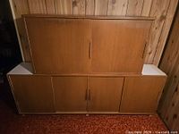 Front view of mid-century veneer sideboard with upper hutch, showing sliding doors and handles