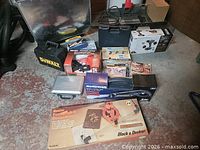 Group shot of all boxed and cased tools on floor