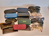 Group shot of eyeglasses, sunglasses and cases