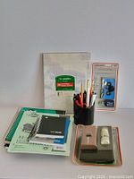 Group shot of notebooks, letterhead pad, pen cup, record cleaning kit, cassette cleaner
