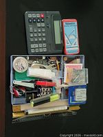 Overall lot showing calculator, tin and desk organizer with contents