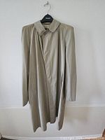 Front view of beige/tan Tomex trench coat on hanger
