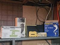 Overall lot on shelf showing all boxed items, DeWalt case and tool bag