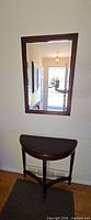 Console table below mounted mirror showing both items together