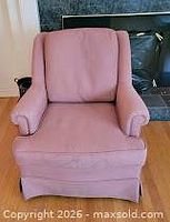 Front view of pink woven fabric armchair with cushions