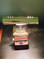 Front view of brass lamp illuminated, View-Master viewer beneath