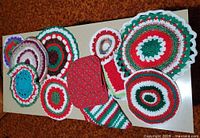 Top view of entire assortment showing crocheted doilies and two potholders