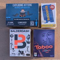 Four factory sealed board games shown from front: Exploding Kittens, Blockbuster, Balderdash, Taboo.