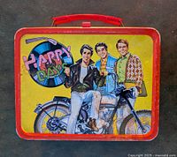 Front side of lunch box showing three Happy Days characters with motorcycle and record graphic.