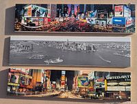 Three canvas prints stacked showing colorful night scenes of Times Square and a black and white NYC skyline panorama.