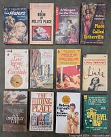 Front covers of 12 vintage paperback pulp fiction books arranged in two rows of six.