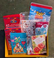 Photo of multiple unopened Valentine's boxes and packs including Mickey Mouse, Mr. Seven Dwarfs, and Toy Story sticker card kit.