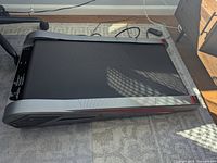 Photo of the treadmill showing the full walking surface, black belt, and gray outer frame with power cord.