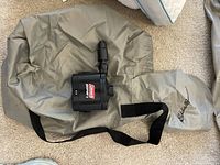 Eddie Bauer branded inflatable air mattress deflated with Coleman electric pump and storage bag.