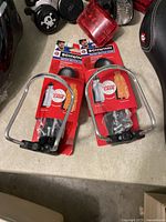 Photo showing two Schwinn water bottle cages in original packaging along with multiple bike lights and reflectors, part of a lot of miscellaneous bike supplies.